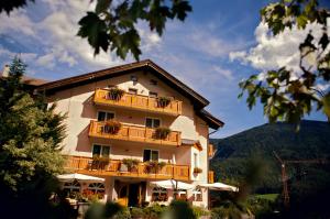 a building with balconies and potted plants on it at Hotel Michela in Malè