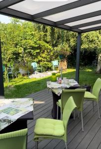 a patio with a table and chairs on a deck at Pension zur Perle in Büsum