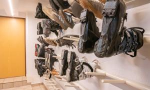 a bunch of shoes hanging on a wall at Hotel Wechselberger by Alpeffect Hotels in Saalbach-Hinterglemm