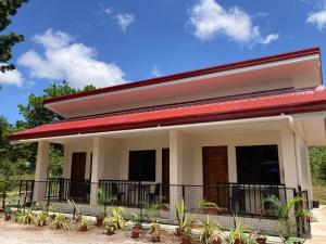 a house with a red roof at Simon Guest House in San Juan