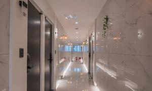 a hallway of a building with lights on the walls at Daejeon Comma Hotel in Daejeon +21 photos