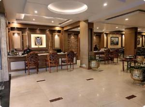 a lobby with chairs and tables in a building at HOTEL SAHANA CASTLE in Nāgercoil