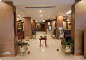 a lobby of a hotel with a table and plants at HOTEL SAHANA CASTLE in Nāgercoil