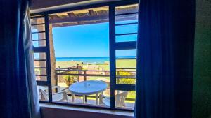 a view of the beach from a room with a window at Allesreg Chalet B2 in Margate
