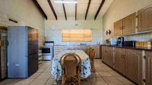 a kitchen with a table and a refrigerator at Allesreg Chalet B2 in Margate