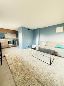 a living room with a bed and a table at Haven Home in Stavanger
