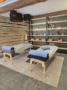 two beds sitting in a room with a wall at Le Cerf d'Or in Herbeumont