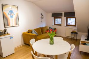 a living room with a white table and a couch at Apartamenty Centrum Biskupiec in Biskupiec