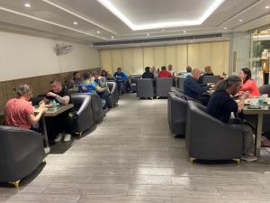 a group of people sitting at tables in a room at Hotel Gold The Royal A Luxurious Stay- Near New Delhi Railway Station & Connaught Place in New Delhi