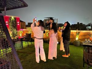 a group of people playing a video game at a party at Hotel Gold The Royal A Luxurious Stay- Near New Delhi Railway Station & Connaught Place in New Delhi