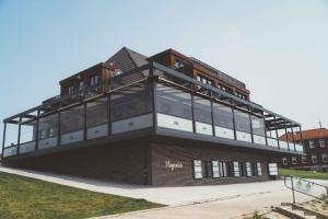 a building with a lot of windows on top of it at Fliegerdeich Hotel & Restaurant in Wilhelmshaven +156 photos