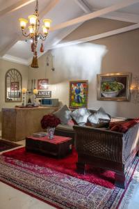 a living room with a couch and a table at Red olive guesthouse in Parys