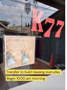 a sign in the window of a restaurant at K77 Backpackers - Jungle Tours in Medan