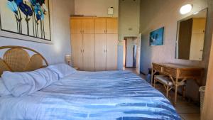 a bedroom with a bed and a dresser and a desk at Allesreg Chalet B2 in Margate +10 photos