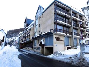 a building on a street with snow on the ground at Résidence Lienz - Studio cabine avec terrasse exposï¿½e Sud MAE-8324 in Barèges +3 photos