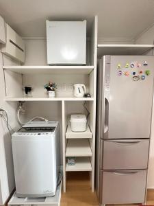 a kitchen with a refrigerator and a stove at Ueno 10minutes, Tokyo University 10minutes, three BR, three toilets, Max 10 people Free parking in Tokyo