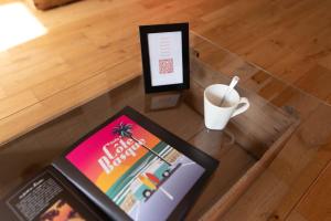 a table with a book and a cup of coffee at Beautiful House avec AC climatisation - terrasse privée - Côté pavé centre-ville Toulouse in Toulouse