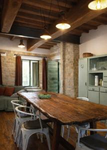 a dining room with a wooden table and chairs at Casa Vecchia in Colsantangelo