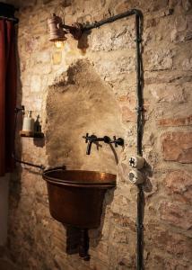 a stone bathroom with a sink in a stone wall at Casa Vecchia in Colsantangelo