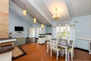 a kitchen and dining room with a table and chairs at The Siena Village in Chinnakanal