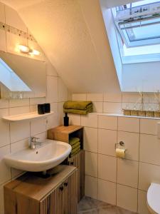 a bathroom with a sink and a skylight at Bachbauer am Attersee in Weyregg +40 photos