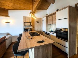 a kitchen with a wooden island in a room at Chalet Adele - Appartement 6 personnes situé en bord de piste St Martin de Belleville MAE-8204 in Saint-Martin-de-Belleville