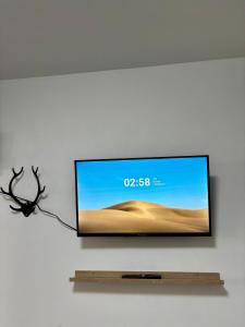 a flat screen tv hanging on a wall at SeaStep Apartment Golem in Golem