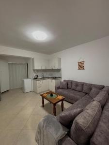 a living room with a couch and a table at SeaStep Apartment Golem in Golem