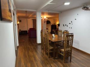 a dining room with a wooden table and chairs at The Woodside Manor in Nuwara Eliya +36 photos