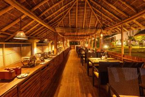 a dining room with tables and chairs in a restaurant at The Siena Village in Chinnakanal