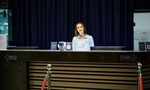 a woman is standing behind a reception desk at Hotel Planai by Alpeffect Hotels in Schladming +65 photos