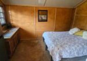 a small bedroom with a bed and a desk at Deltrade Wedding and Camp in Pretoria +24 photos