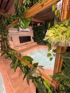 an indoor pool with plants in a building at Studio Nessa with a private jacuzzi in Krk