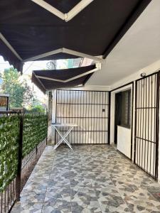 a patio with a table and a umbrella on a fence at SeaStep Apartment Golem in Golem