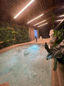 a swimming pool with water in a building at Studio Nessa with a private jacuzzi in Krk
