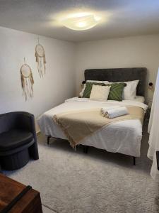 a bedroom with a large bed and a chair at Studio Nessa with a private jacuzzi in Krk +20 photos