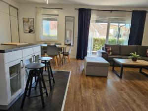 a kitchen and living room with a couch and a table at Apartment Rita in Mokošica