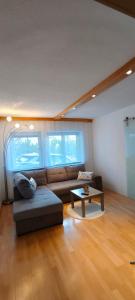 a living room with a couch and a coffee table at Alpenblick in Trofaiach +4 photos
