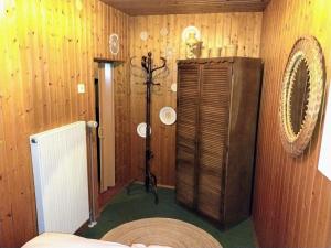 a room with a wood paneled wall with a room with aperature at Ferienhaus Waldkrone in Arrach