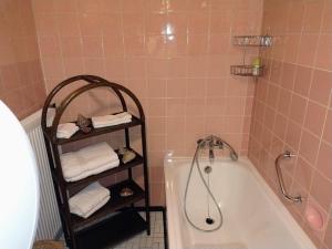 a bathroom with a bath tub and a rack with towels at Ferienhaus Waldkrone in Arrach