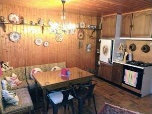 a kitchen with a table and a dining room at Ferienhaus Waldkrone in Arrach
