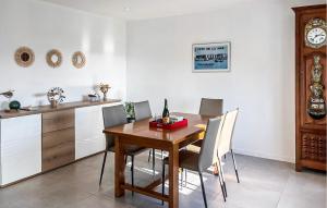 a dining room with a wooden table and chairs at Kerarmoor in Plouhinec