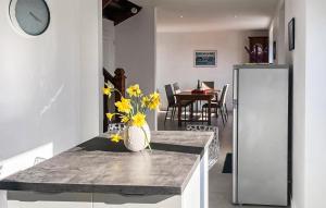 a living room with a table with a vase of yellow flowers at Kerarmoor in Plouhinec +26 photos
