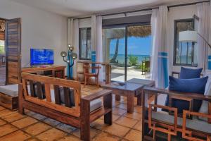 a living room with a view of the ocean at Villa Mora Mora in Nosy Be