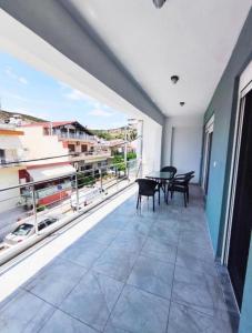 a large balcony with a table and chairs on it at Beachway luxury studio C in Nea Peramos