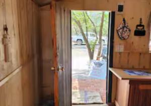 an open door of a tiny house with a porch at Deltrade Wedding and Camp in Pretoria