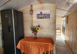 a table with a vase of flowers on top of a refrigerator at Deltrade Wedding and Camp in Pretoria