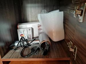 a wooden shelf with a telephone and a box at The Cliff Lodge Ella in Ella