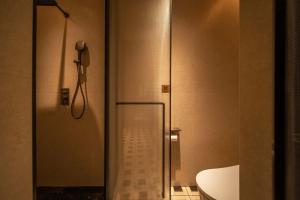 a bathroom with a shower and a glass door at PORTAL ART HOTEL in Fengjie