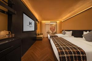 a hotel room with two beds and a flat screen tv at PORTAL ART HOTEL in Fengjie +105 photos